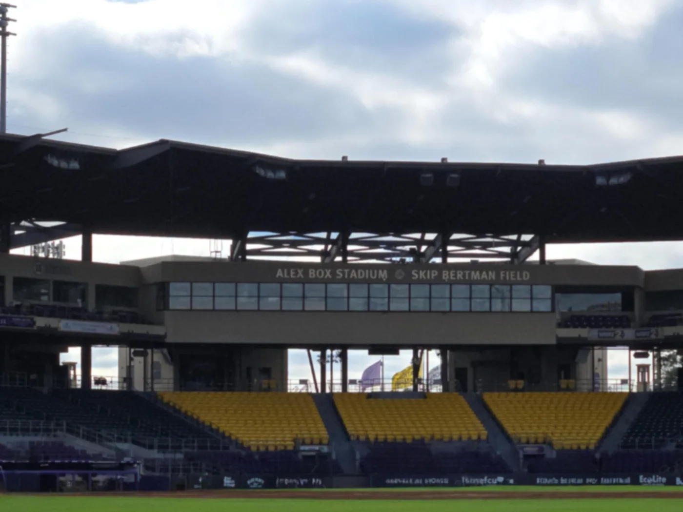 Yellow seating below the covered grandstand at LSU’s Alex Box Stadium.