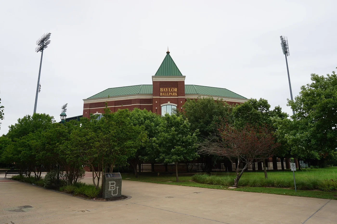 Brick entrance building and trees outside Baylor Ballpark in Waco in 2016.