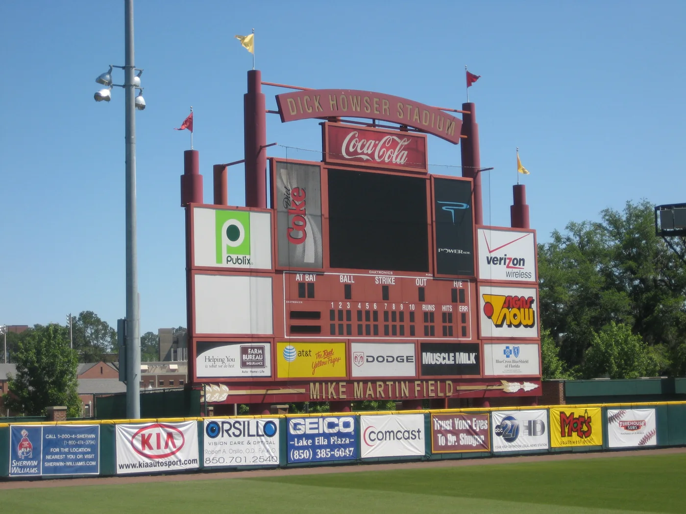 Baseball scoreboard and outfield advertising at Florida State’s Dick Howser Stadium.