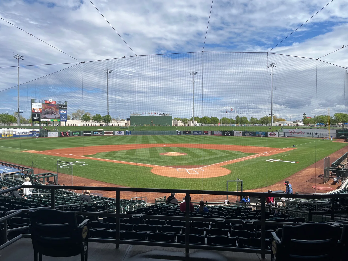 Surprise Stadium baseball diamond viewed through protective netting before a 2023 game.
