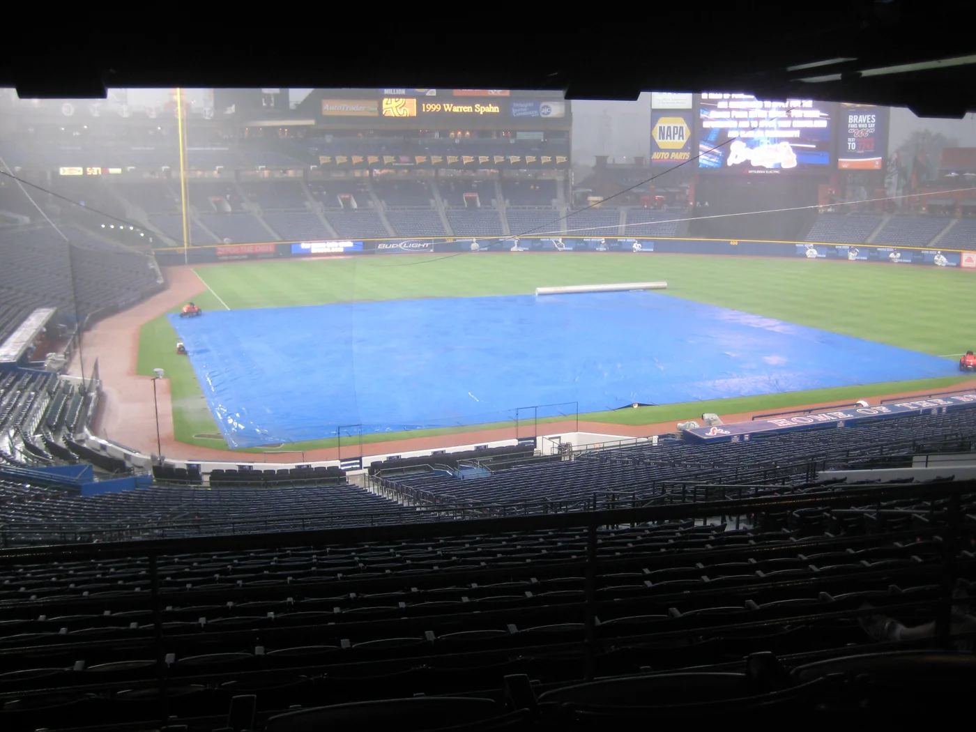 Blue tarp covering the Turner Field infield during a nighttime rain delay.